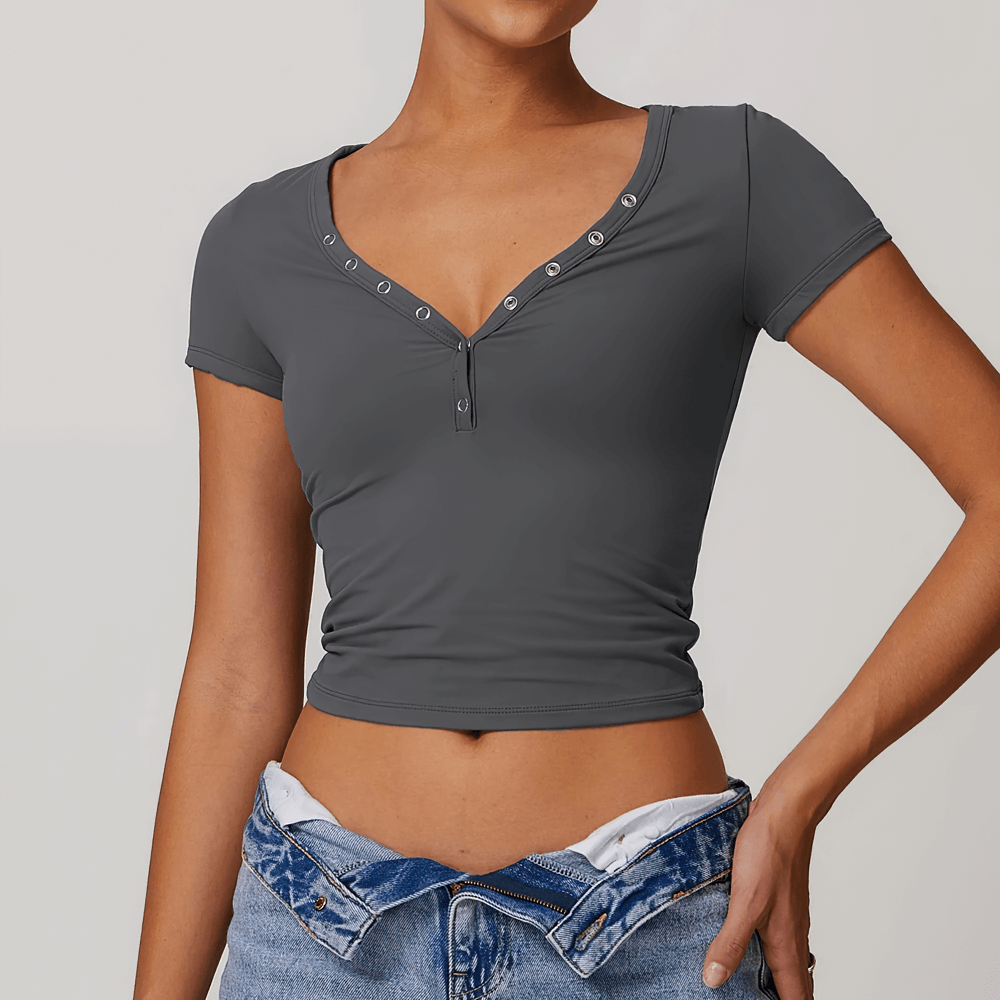 Woman in black V-neck short sleeve yoga T-shirt with button design, perfect for fitness or casual wear. SF2426.